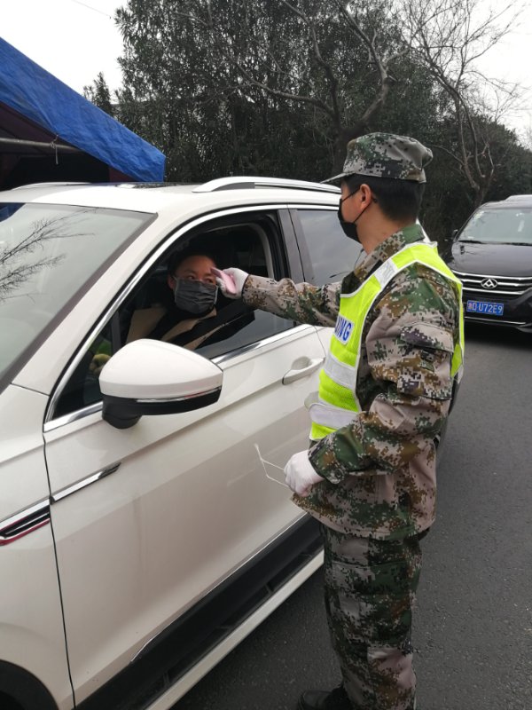 新对旗山村防疫情志愿者严守卡口，并测量体温